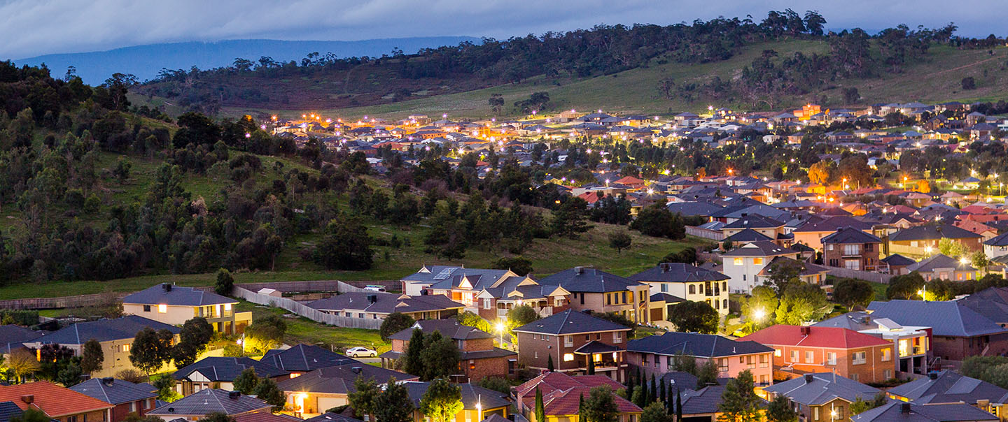 View looking over a town in a small valley at dusk