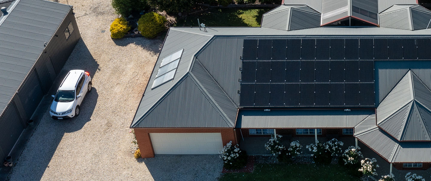 Aerial view of a house with solar panels on the roof