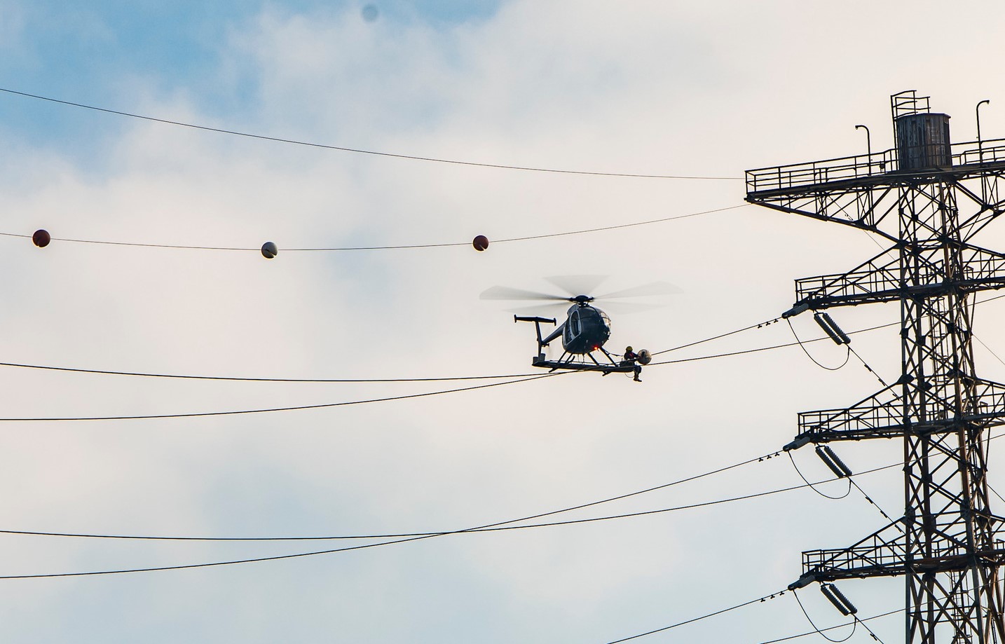 A helicopter flying near powerlines