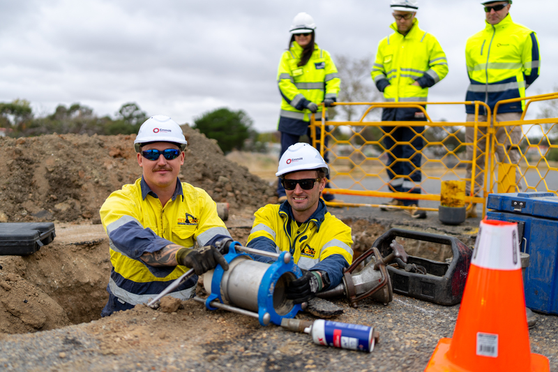 A group of people outside with gas line repair equipment