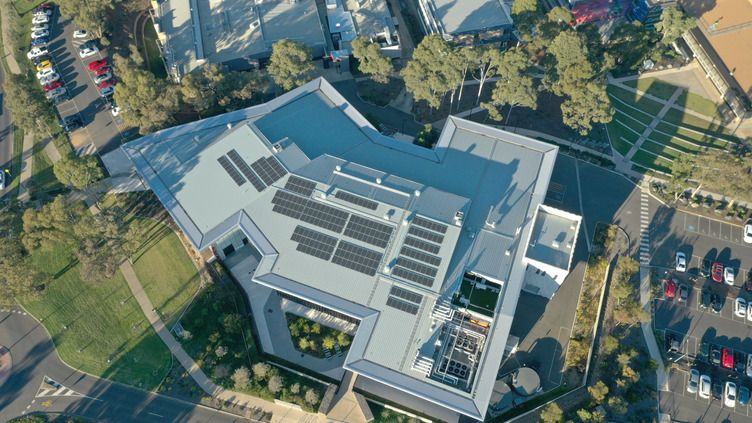 An aerial view of solar panels on a roof