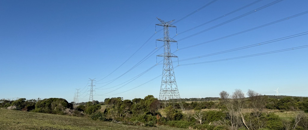 Transmission towers spanning a field
