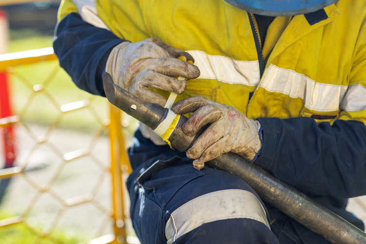 A screw being applied to a gas pipe
