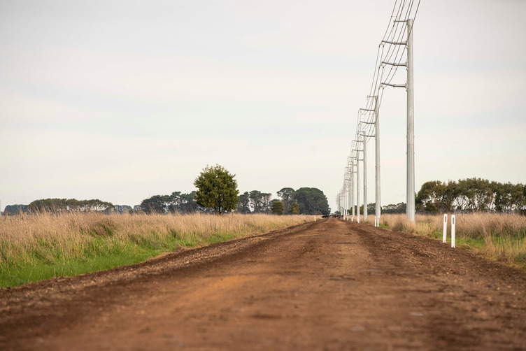 Powerlines spanning along a dirt road