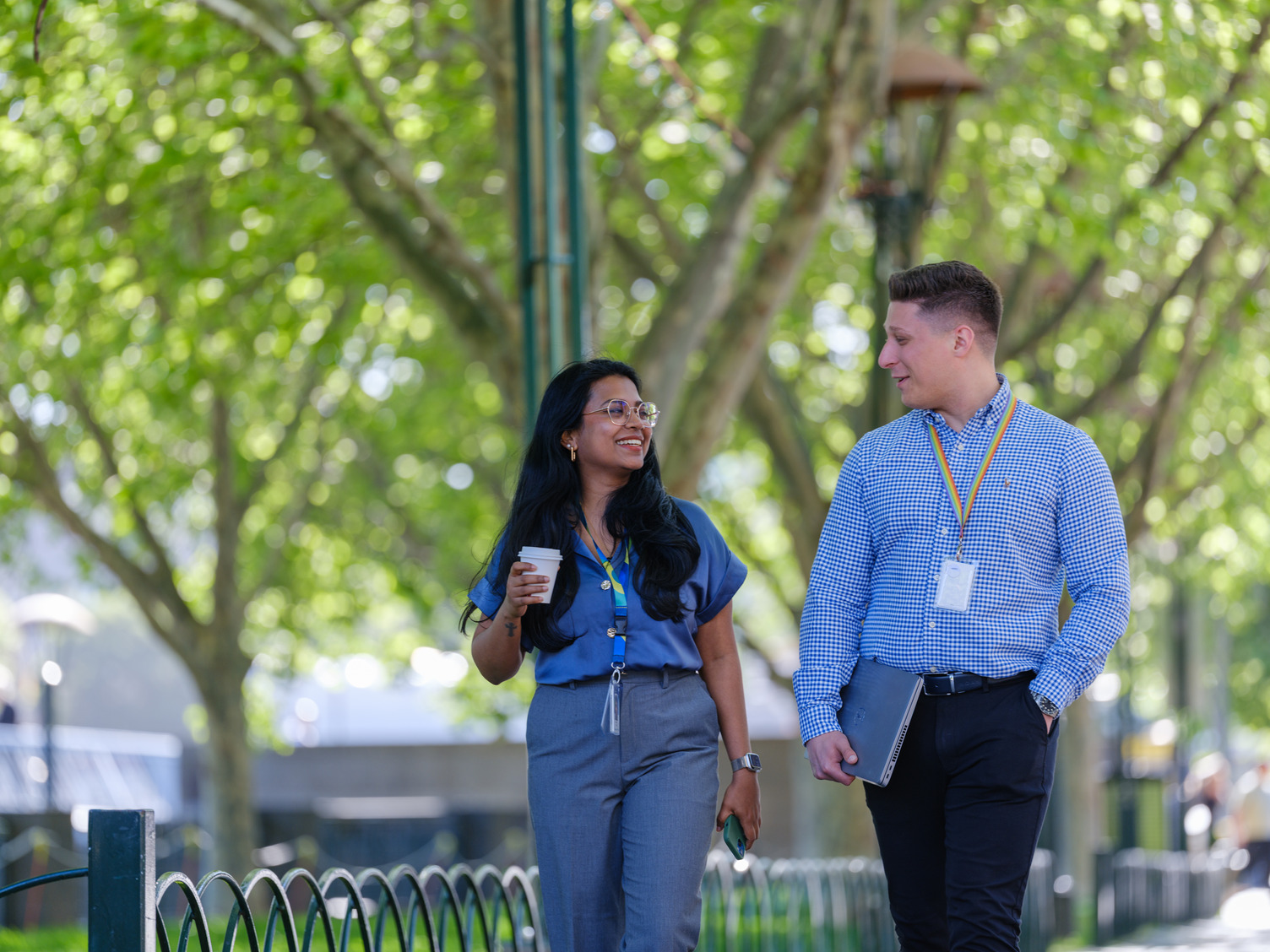 A smiling man and woman walking outside