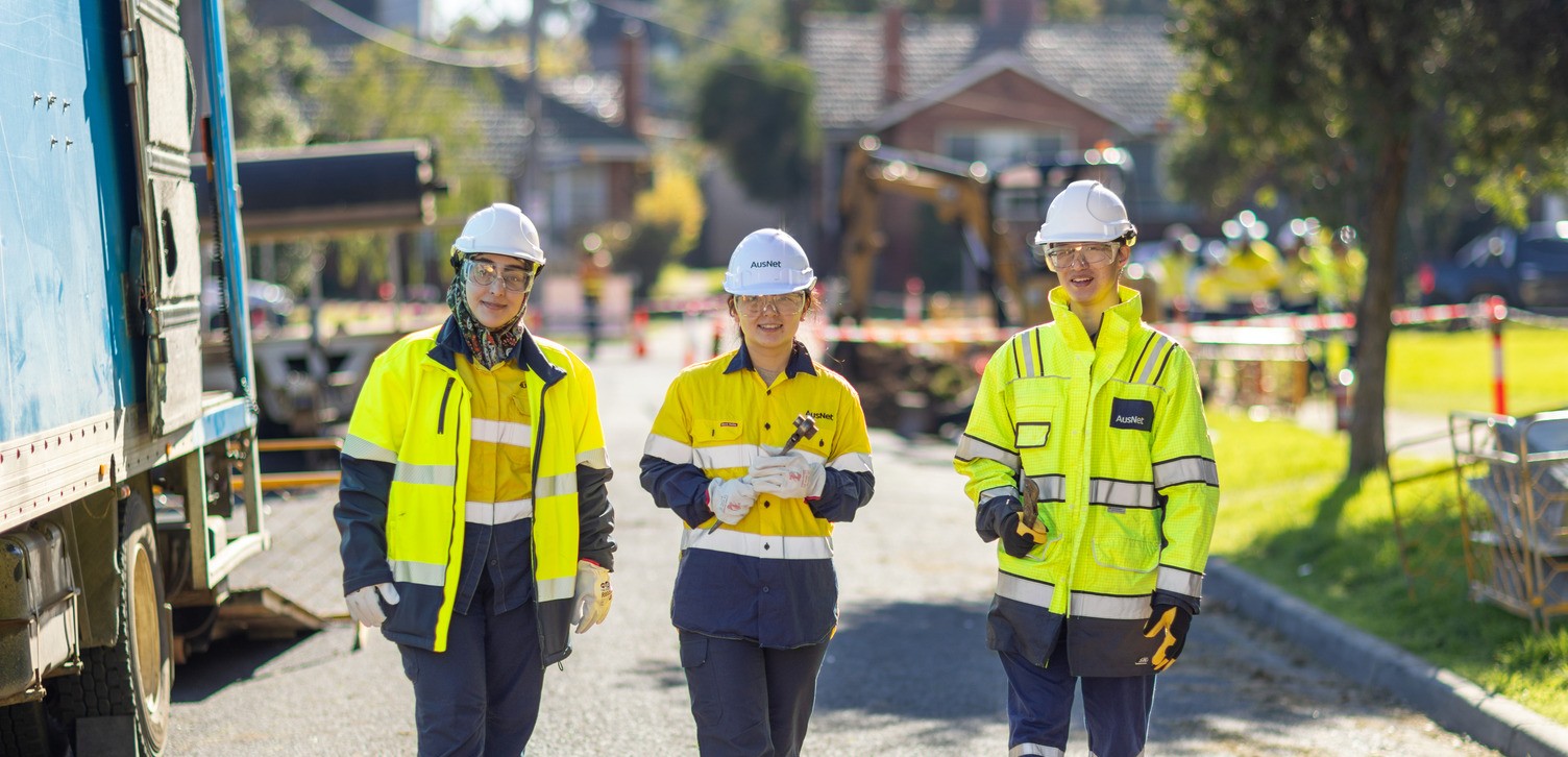 Three gas workers on a street