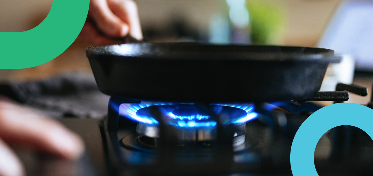 A pan being placed on a lit gas stove