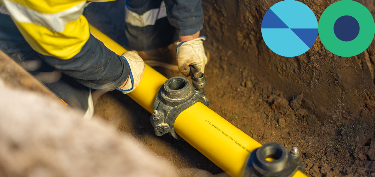 A worker securing a gas pipe