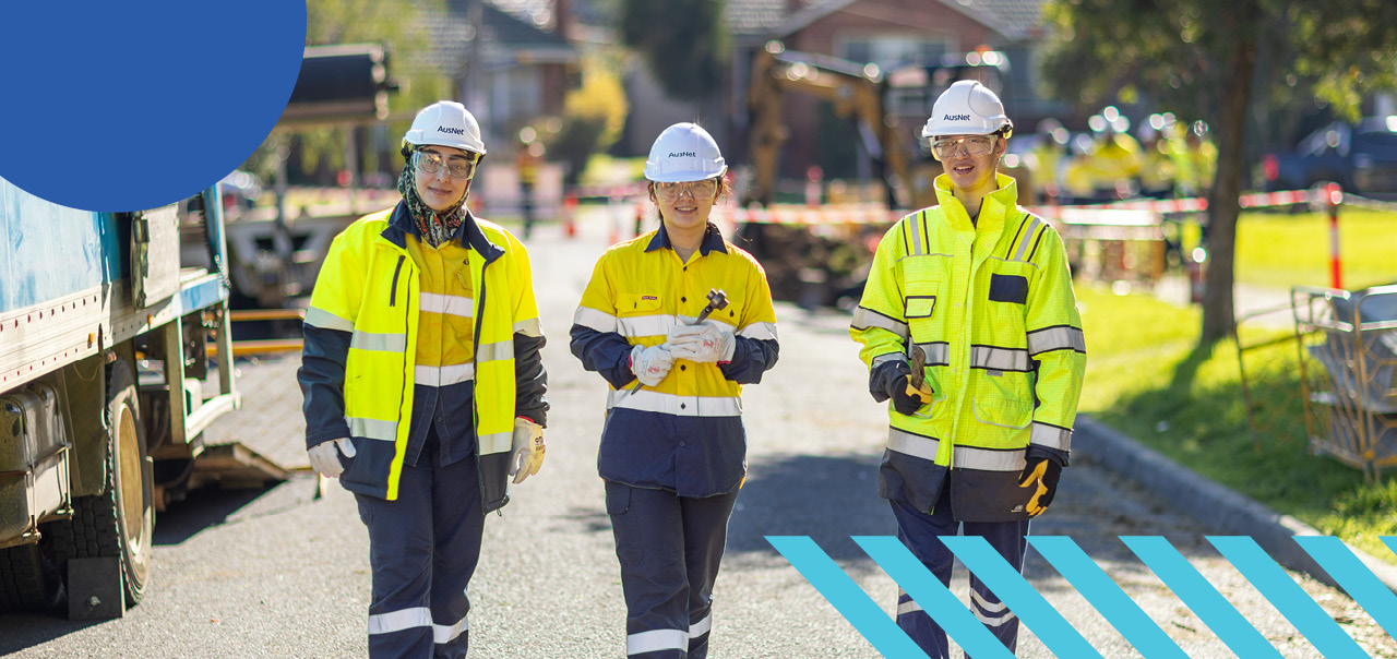 Three workers standing on a street