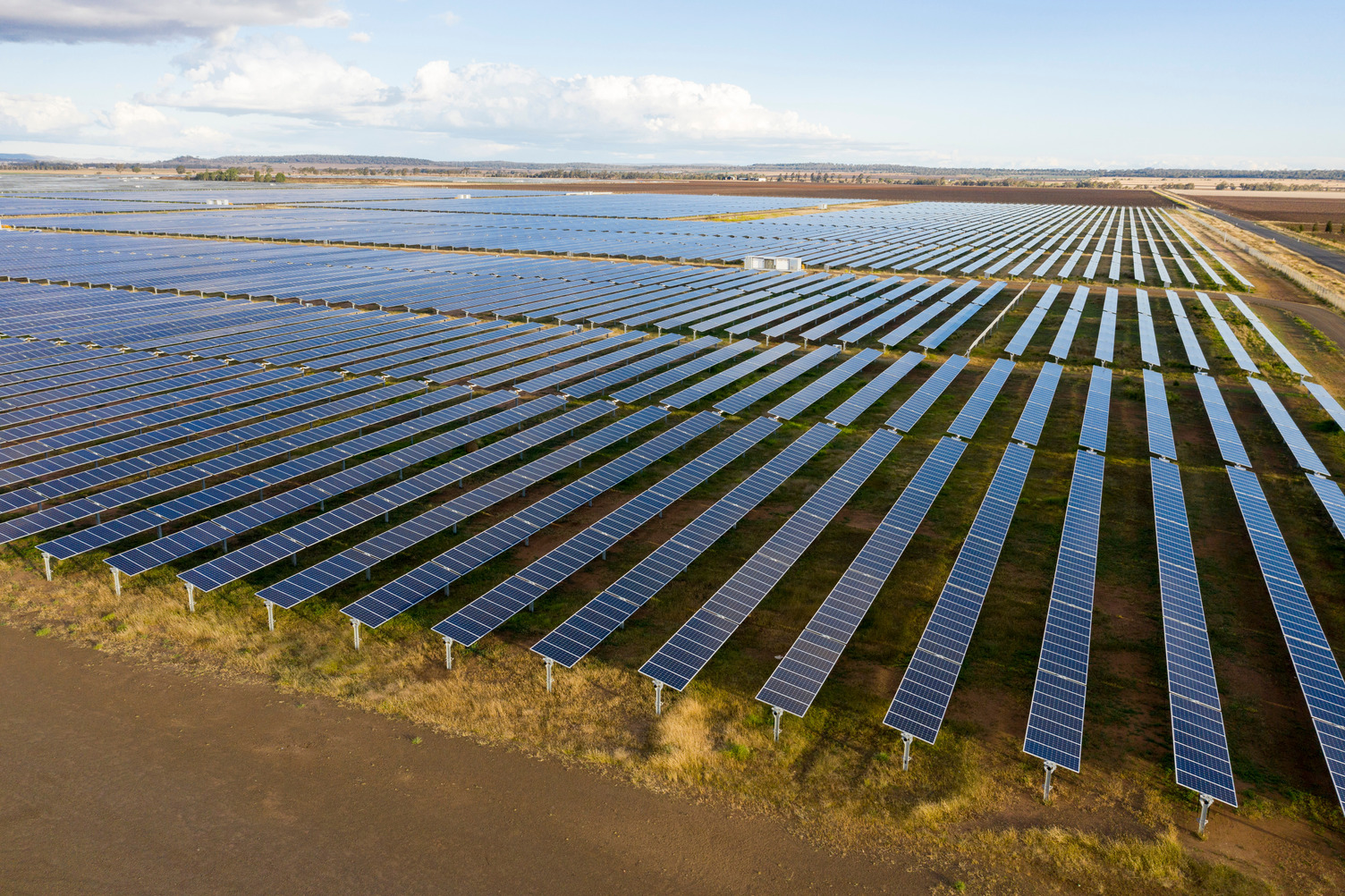 A solar farm with long rows of large solar panels