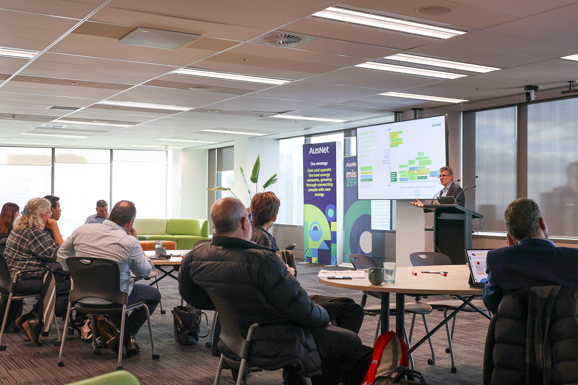 A group of people in an office, attending a workshop