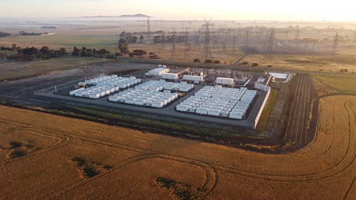 aerial perspective of high voltage powerlines and battery storage for renewable energy
